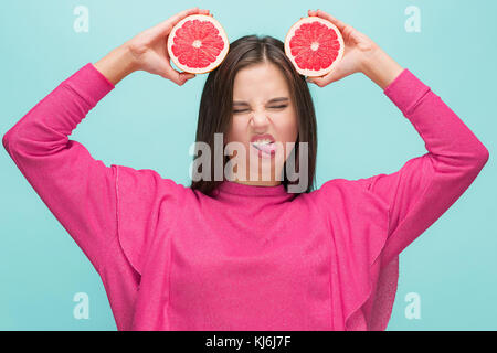 Pretty woman with delicious grapefruit in her arms. Stock Photo
