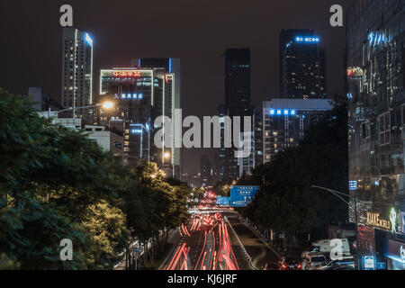 Long exposure view of street in Chengdu at night with skyscrapers in background, Sichuan Province, China Stock Photo