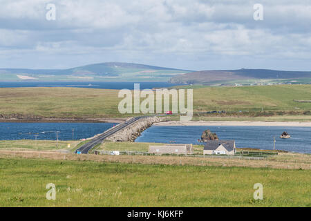 A961 on Churchill Barrier No 3 across Weddell Sound looking from Burray towards Glims (Glimps) Holm, with block ships visible on the right, Orkney Stock Photo