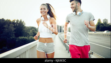 Attractive man and beautiful woman jogging together Stock Photo