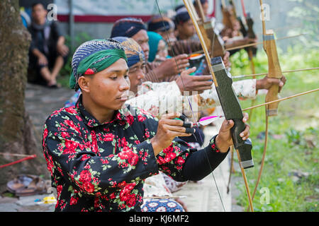 Indonesian men practicing Jemparingan / traditional Javanese archery by shooting bow and arrows in the city Yogyakarta, Java, Indonesia Stock Photo