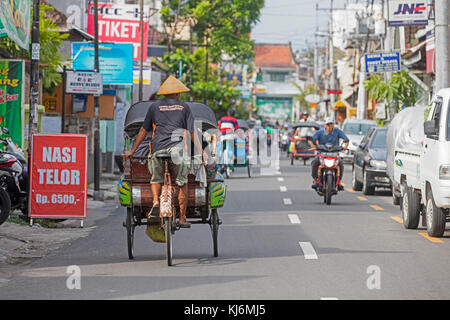 Cycle rickshaws / becak for public transport in the city Yogyakarta, Java, Indonesia Stock Photo