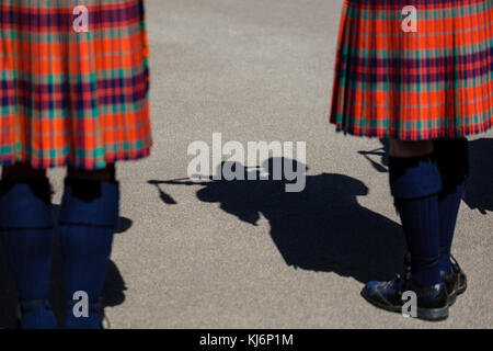 Shadow of a man wearing a kilt and playing bagpipes Stock Photo