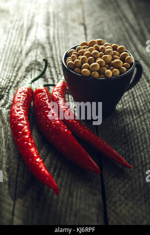 Macro photo of Organic Chili Peppers and soy beans on a wooden table Stock Photo