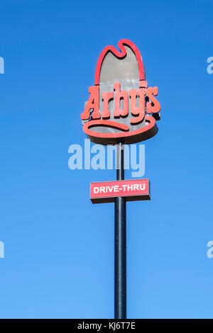 A pole sign of Arby's fast food restaurant against a blue sky in Guthrie, Oklahoma; USA. Stock Photo