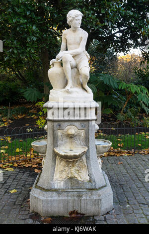 A Victorian drinking fountain in St James' Park in London features a statue of a water carrier by C H Mabey Stock Photo