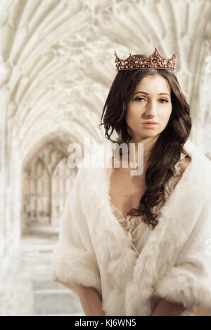 Woman wearing a crown standing in her ivory tower Stock Photo