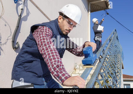 man working with grinder outdoors Stock Photo