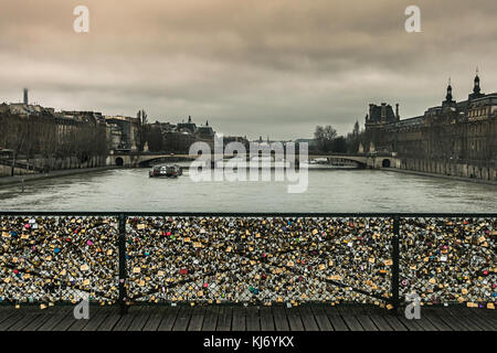 Love locks in Paris. Scene from the 'Pont des Arts' on an overcast day. Locks has been removed since this shot was taken. Stock Photo