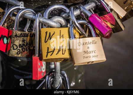 Lots of colorful love locks on the Arts Bridge in Paris, France. Stock Photo
