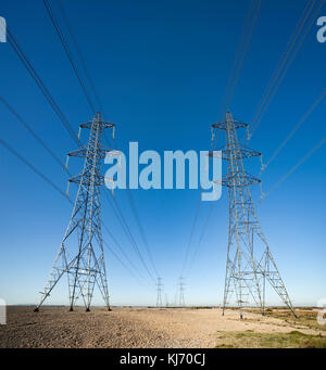 Electricity pylons at Dungeness, Kent. Stock Photo