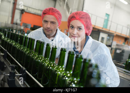 professional workers using machine in wine factory Stock Photo