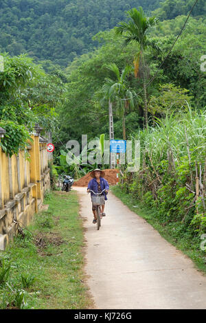Villagers cycling in the Mai Chau ricefield area in rural Northwest Vietnam Stock Photo