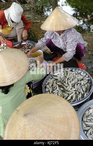 Asian market sellers vending fish Stock Photo