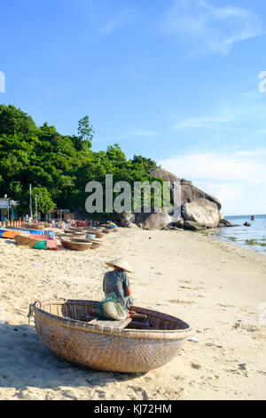 Vietnamese fisherwoman with a traditional round coracle basket boat Stock Photo