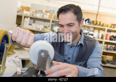 young man repairing trolley Stock Photo