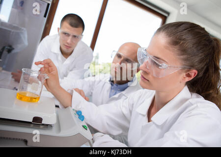 weighing the liquid inside a flask Stock Photo