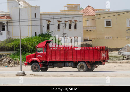 Nouakchott, Mauritania - October 08 2013: Old and classic Coca-Cola truck driving on dirt road in capital Stock Photo