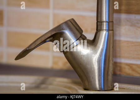 Close-up of faucet handle in the kitchen Stock Photo