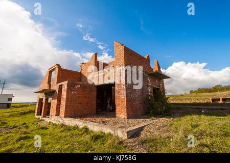 Exterior of an old building under construction. Orange brick walls in a new house. Stock Photo