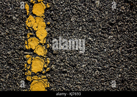 The Yellow line crack on the road Stock Photo