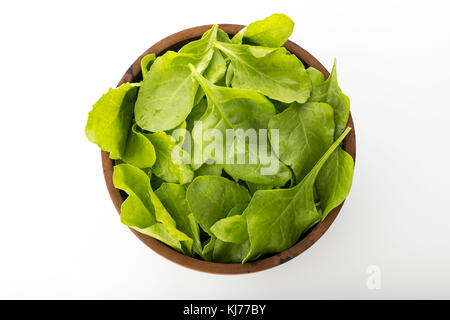 Top View of Fresh Green Spinach Leaves in Wooden Bowl Isolated on White Background Stock Photo