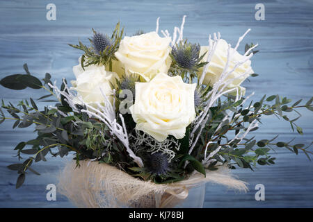 Bouquet of fresh white yellow roses on retro vintage blue background Stock Photo