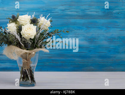 Bouquet of fresh white yellow roses on retro vintage blue background Stock Photo
