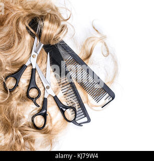 Long blond hair and scissors isolated on white background Stock Photo