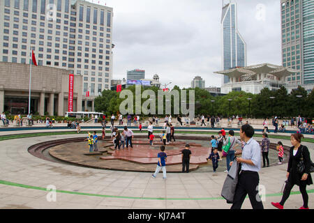 People walk through People's Square Park in central Shanghai, China. Stock Photo