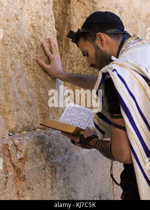 Jewish man praying at Western Wall, Old City, Jerusalem, Israel Stock Photo