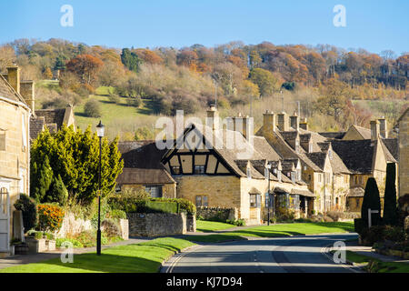 Traditional Cotswold limestone cottages in pretty picturesque Cotswolds village scene below hill in autumn. Broadway Worcestershire England UK Britain Stock Photo