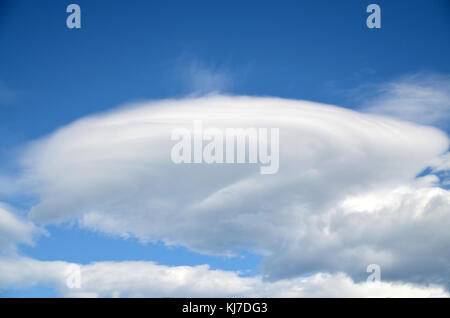 dramatic formation of lenticular cloud. Subtypes of altocumulus cloud. resembles a flying saucer and typically forms in the lee of mountains Stock Photo