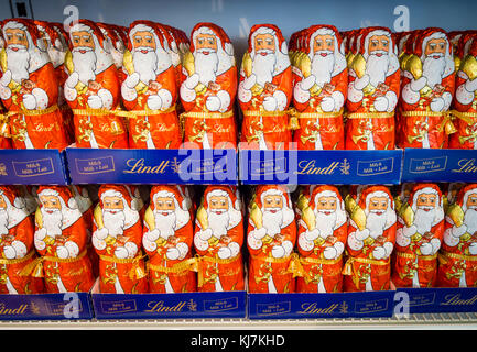 Zurich, Switzerland - 17 Nov 2017: Less than 6 weeks before Christmas, an army of chocolate Santa Clauses is lined up on a supermarket shelf. Stock Photo