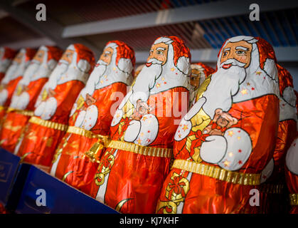 Zurich, Switzerland - 17 Nov 2017: Less than 6 weeks before Christmas, an army of chocolate Santa Clauses is lined up on a supermarket shelf. Stock Photo