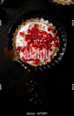 Yogurt Honey Tart covered in fresh pomegranate seeds Stock Photo