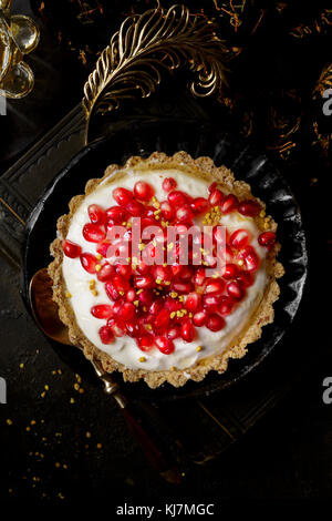 Yogurt Honey Tart covered in fresh pomegranate seeds Stock Photo