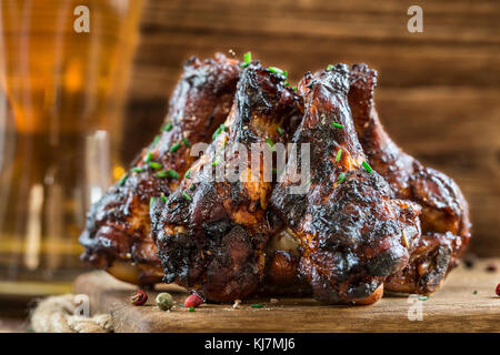 BBQ chicken wings on a wooden board Stock Photo