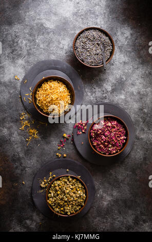 Dried flowers - Lavender,chamomile, rose and marigold on a cookie sheet background Stock Photo