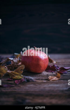 Pomegranate on a rustic wooden table Stock Photo