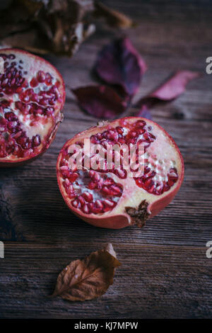 Pomegranate on a rustic wooden table Stock Photo