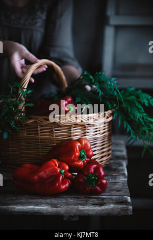 Red peppers on a rustic kitchen table Stock Photo - Alamy