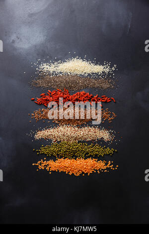 Superfoods and cereals selection for High Energy Lifestyle and Eating Right: sesame, chia seed, goji berry, flax seed, quinoa, mung bean, lentil on da Stock Photo