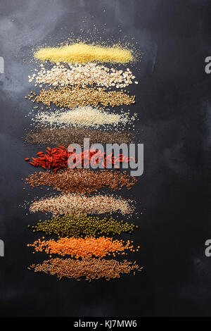Superfoods and cereals selection for High Energy Lifestyle and Eating Right: bulgur, oat-flakes, buckwheat, sesame, chia seed, goji berry, flax seed, Stock Photo