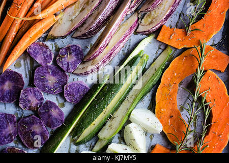 Chopped raw vegetables on baking sheet before roasting. Top view, Food background Stock Photo