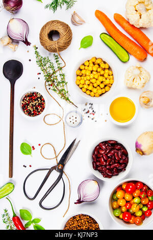 Colorful food ingredients on white background. Bio Healthy food herbs and spices for health cooking. Organic cooking ingredients over white. Diet or v Stock Photo