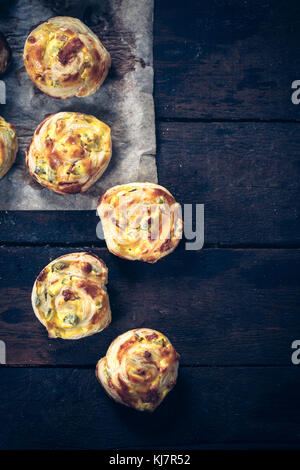 Homemade pastry snack stuffed with ham and cheese on wooden background Stock Photo