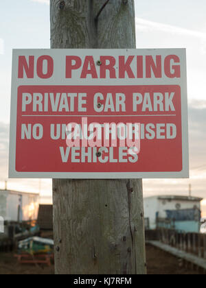 no parking private car park no authorized vehicles sign on post close up; west mersea, essex, england, uk Stock Photo