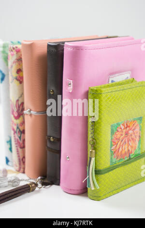 Handmade decorated notebooks and planners of different colors on white background Stock Photo