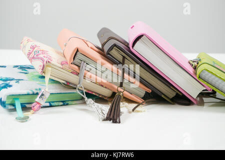Handmade decorated notebooks and planners of different colors on white background Stock Photo